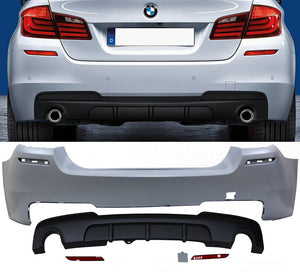 BMW F10 535i rear bumper with single muffler tip twin outlet on a white background.