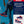 Promotional graphic of Sparco S-Run Martini Racing Sneakers with model, product features, and multiple shoe views against a vibrant trackside backdrop